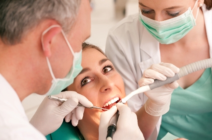 Young woman getting her teeth examined by a dentist